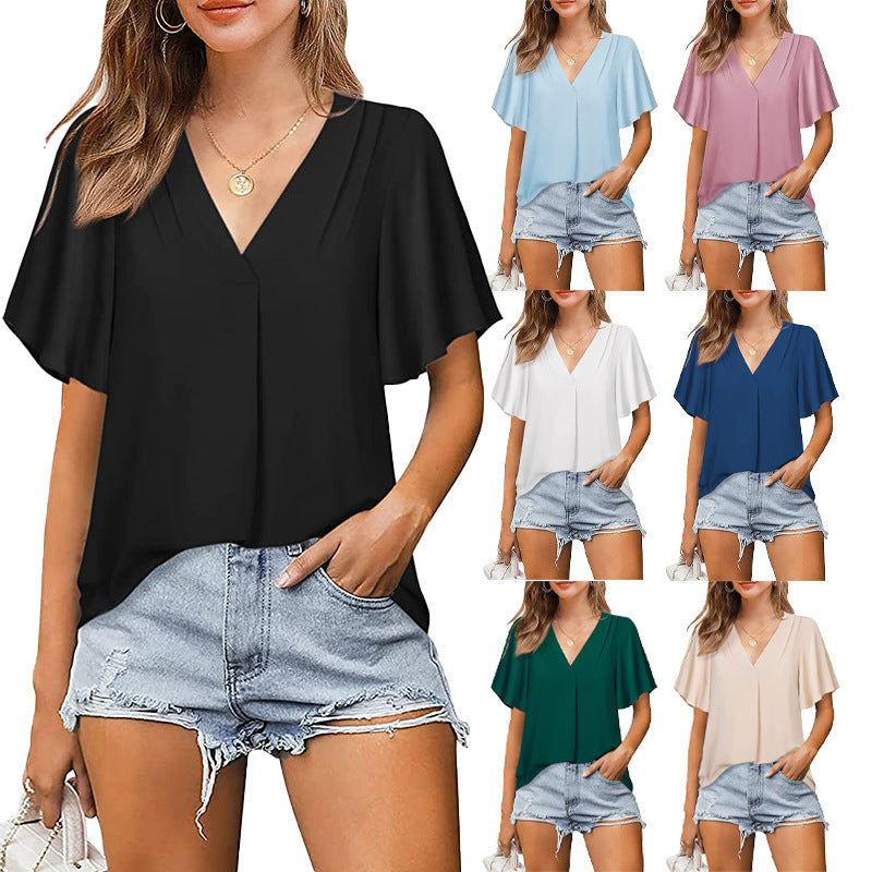 Woman wearing a black top and denim shorts with color swatches of other tops.