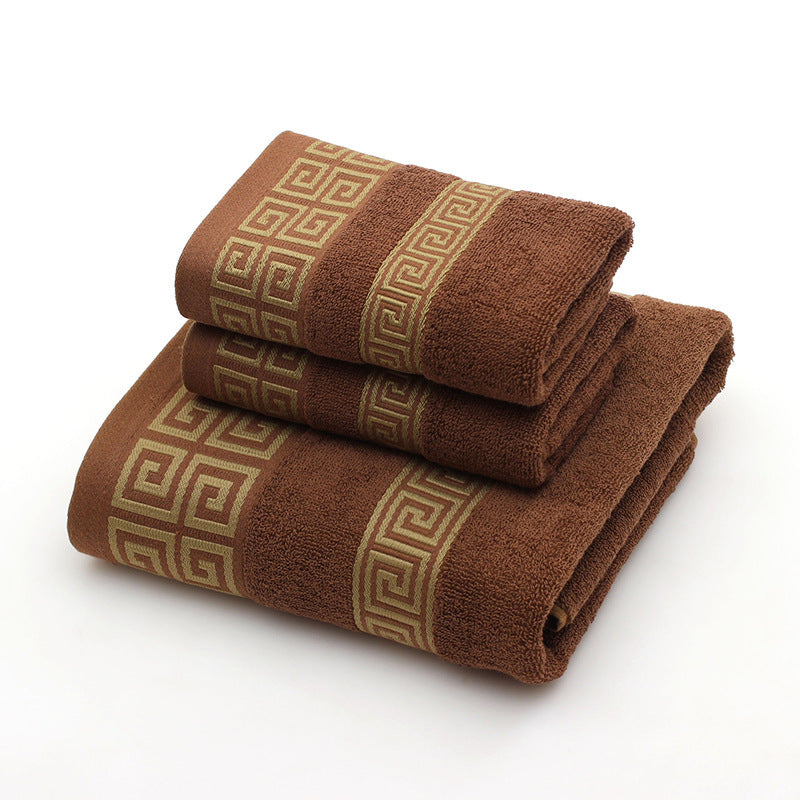 Two brown towels with decorative patterns on a white background