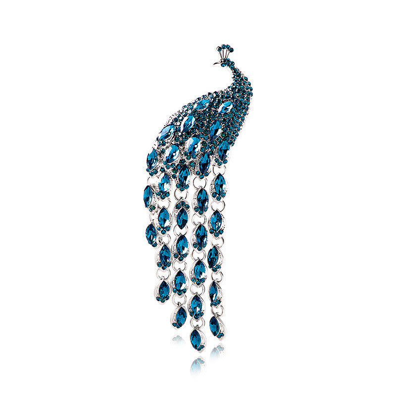 Elegant brooch with blue gemstones on a white background