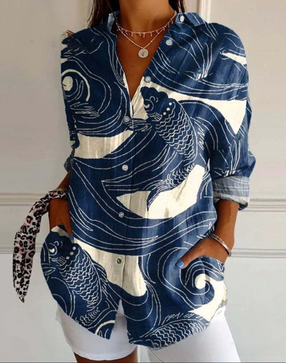 Woman wearing a blue and white patterned shirt with a white background