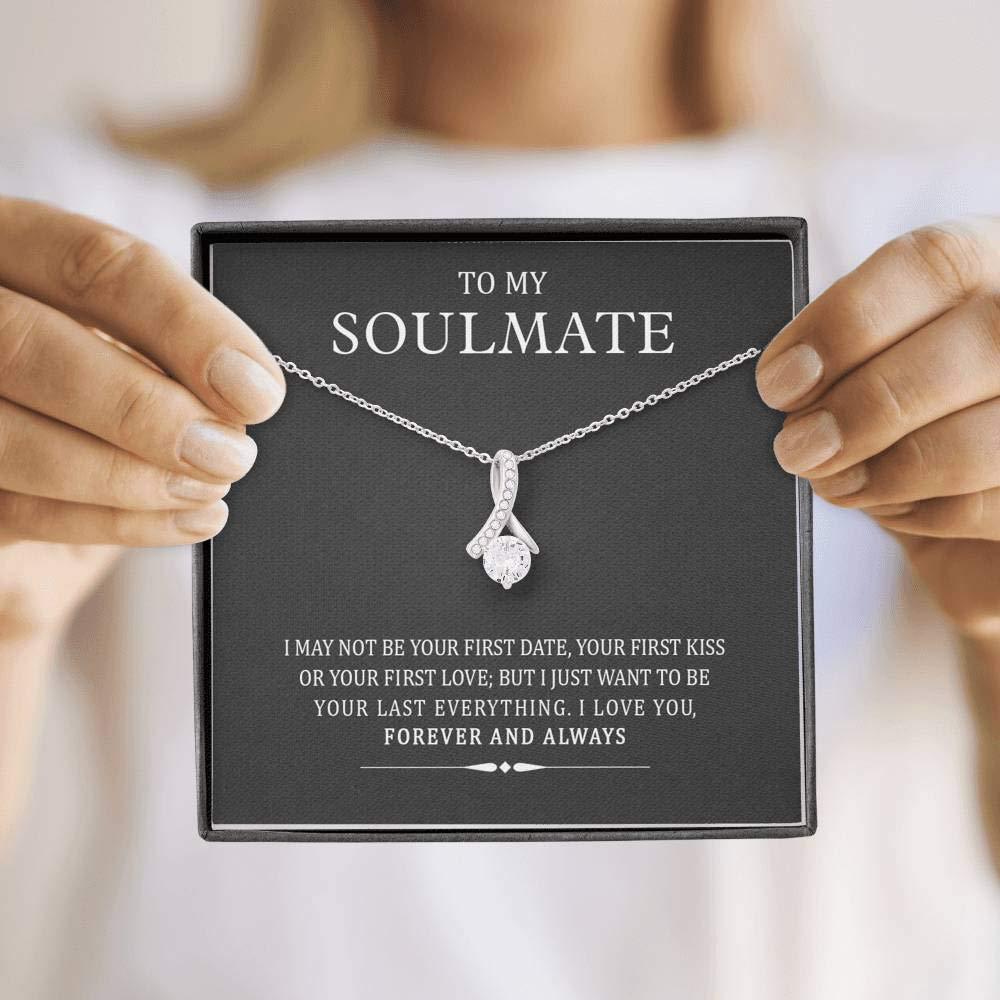 Necklace with a sentimental message card held by hands