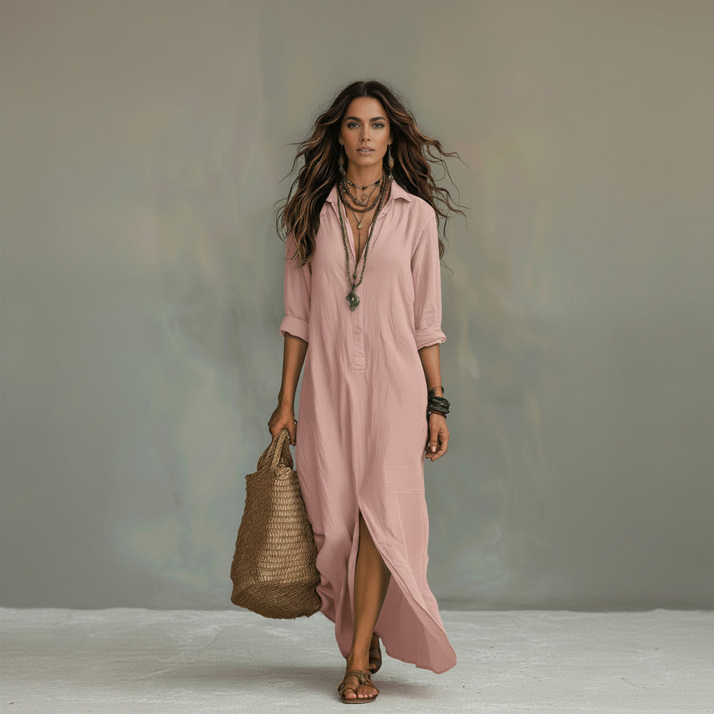 Woman wearing a long pink dress holding a woven bag against a neutral background