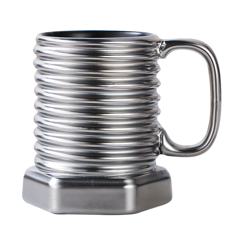 Metallic mug with spiral design and hexagonal base on a white background