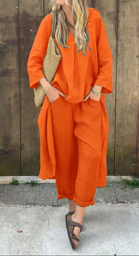 Person wearing an orange outfit with a textured bag against a wooden wall.