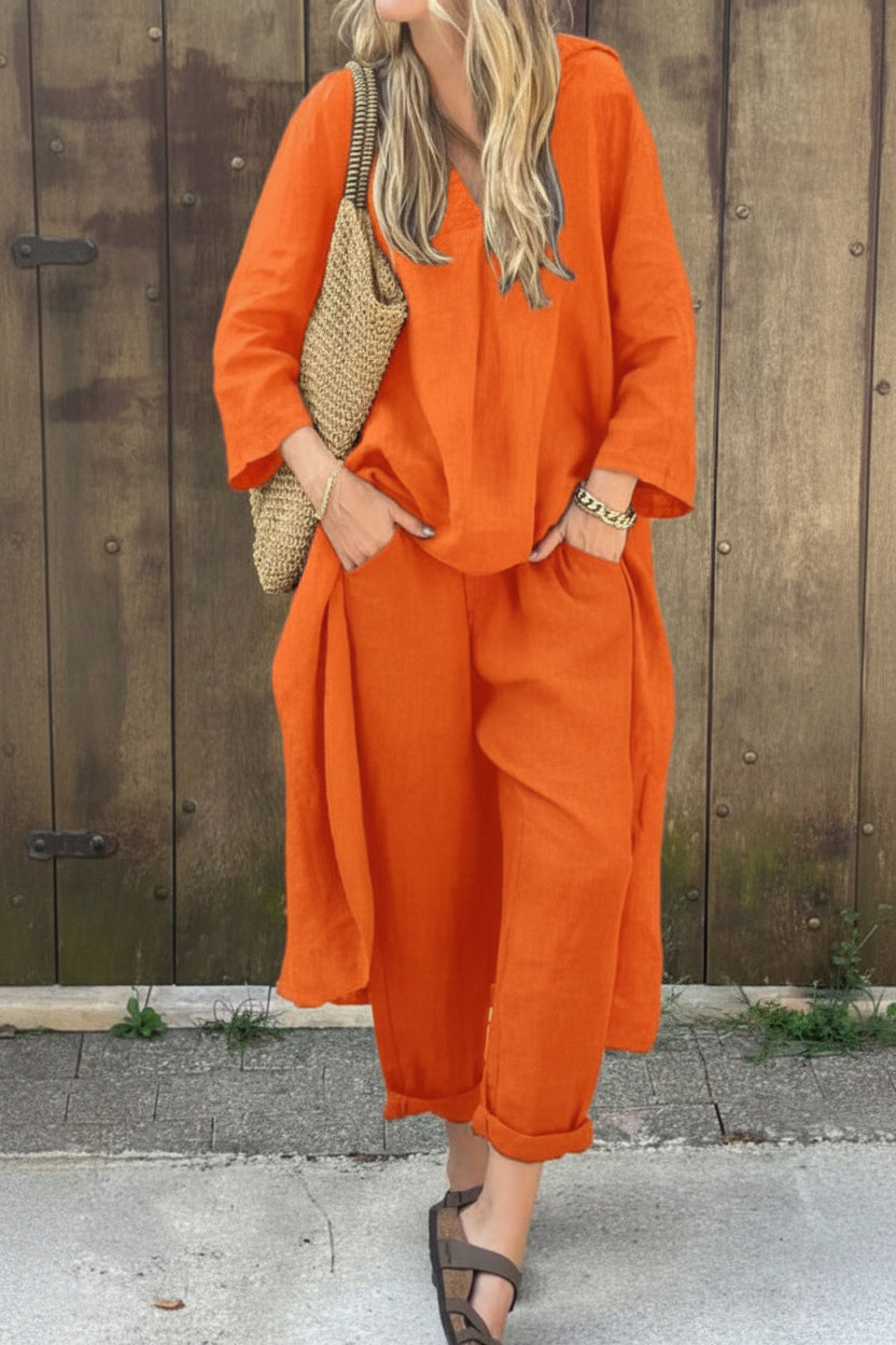 Person wearing an orange outfit with a textured bag against a wooden wall.