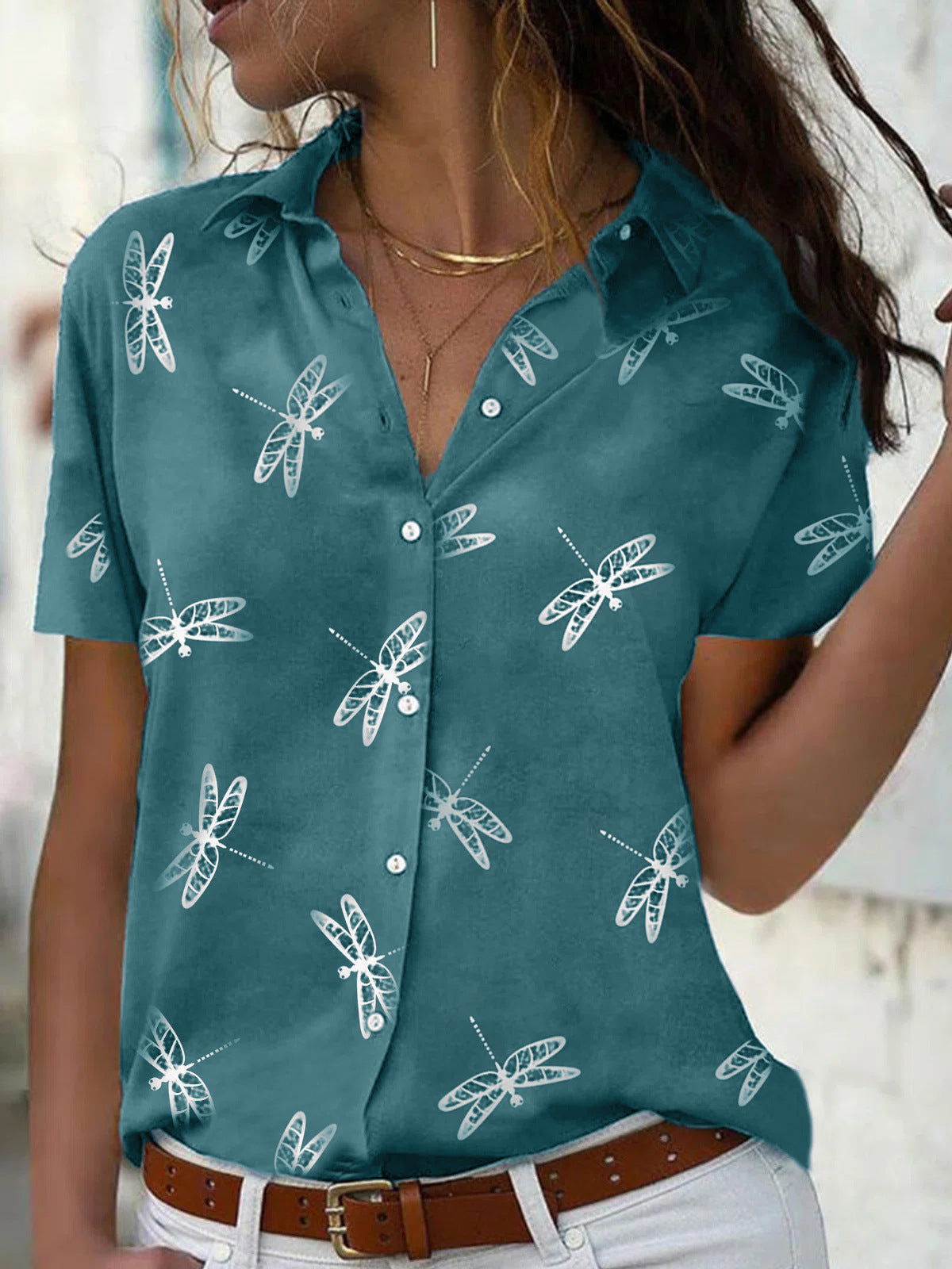 Teal shirt with white dragonfly pattern worn by a person