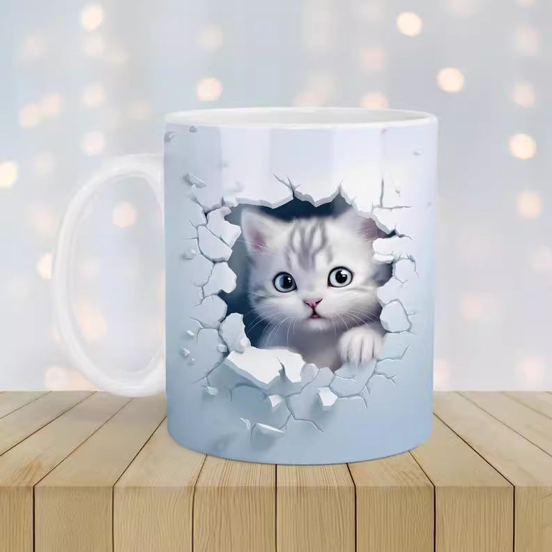 Mug with a design of a cat peering through a broken wall on a wooden surface with a blurred light background