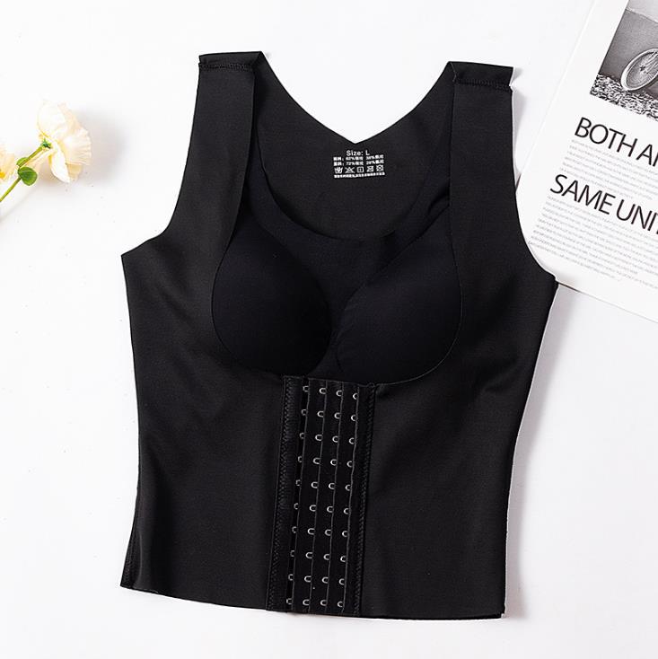 Black waist trainer on a white background with a magazine and flowers.