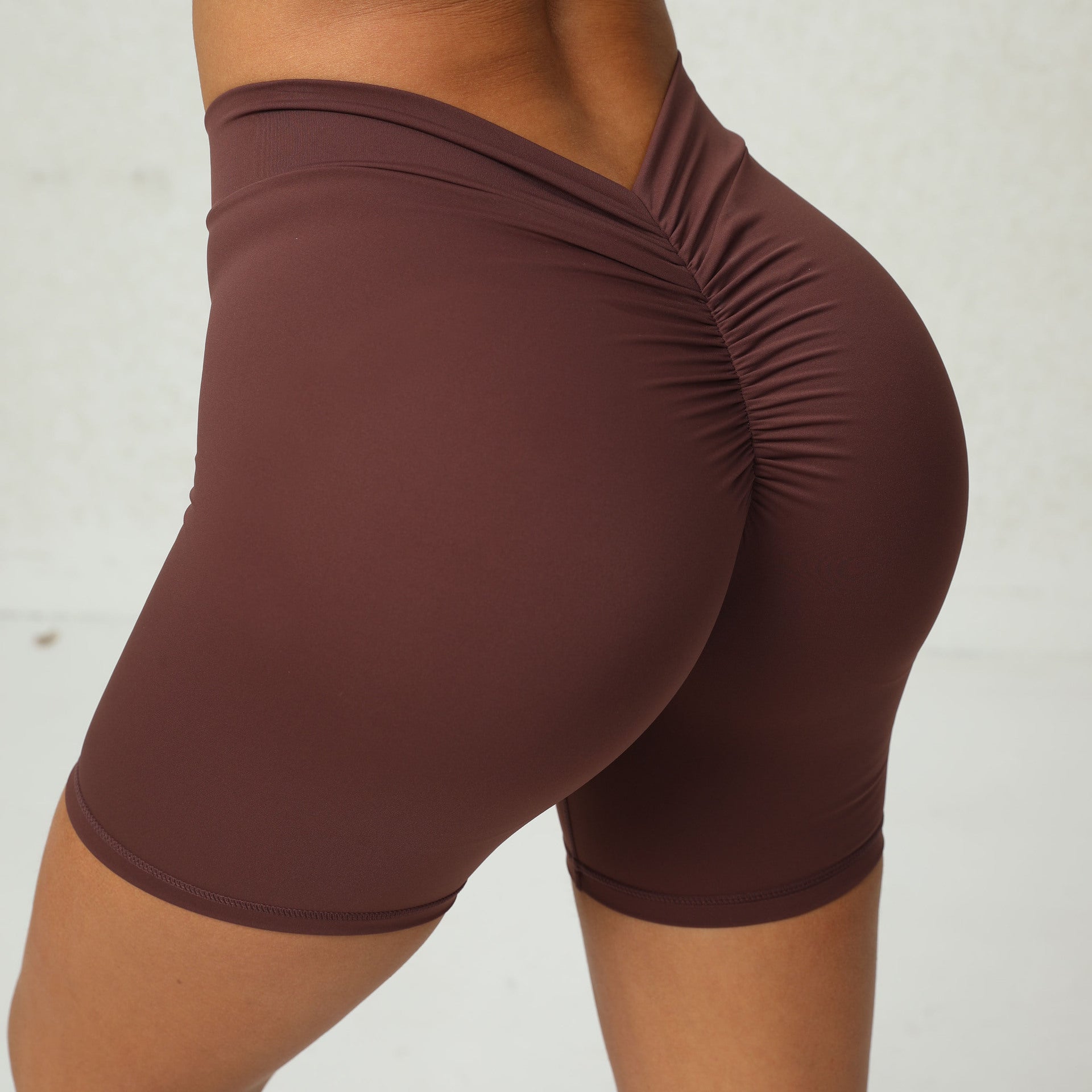 Brown athletic shorts on a plain background