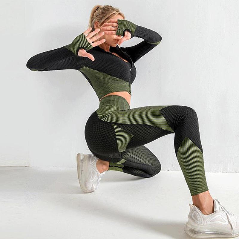 Person wearing a black and green patterned outfit on a white background
