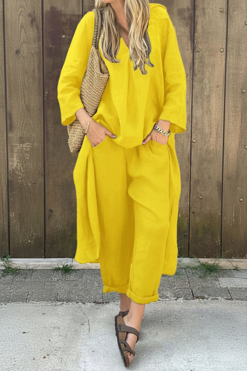 Person wearing a yellow outfit with a wooden background