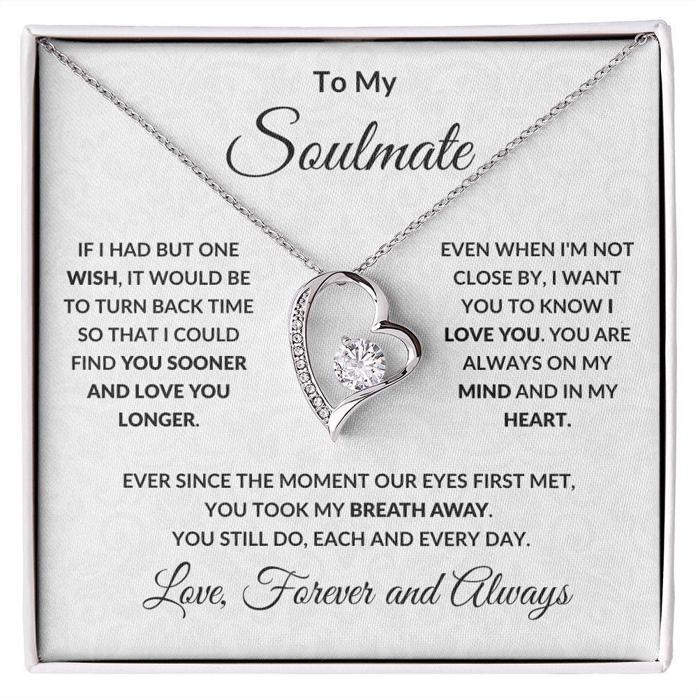 Heart-shaped necklace with sentimental message card on a white background