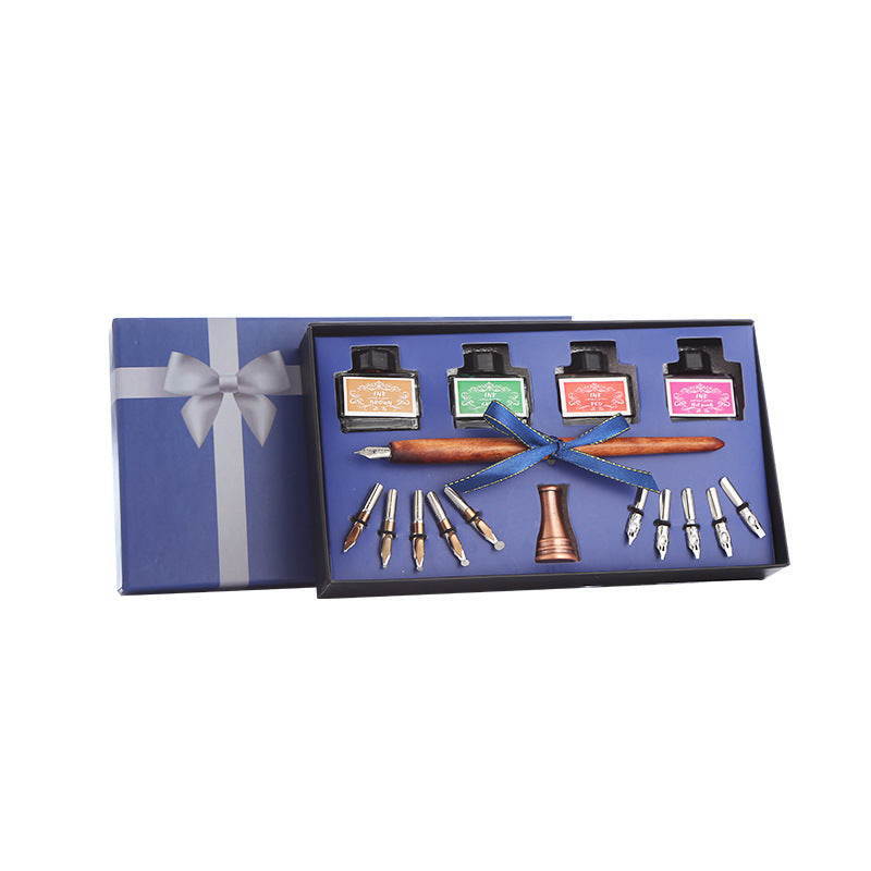 Calligraphy set with ink bottles, pen, and tools in a blue gift box on a white background