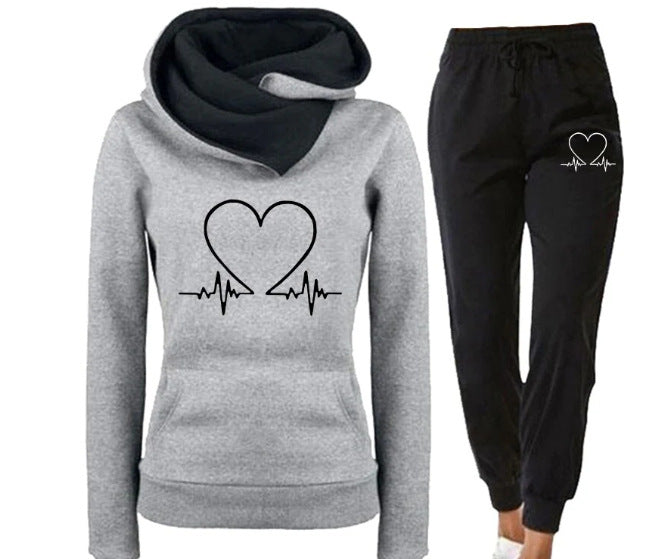 Gray hoodie and black jogger pants with heart design on a white background