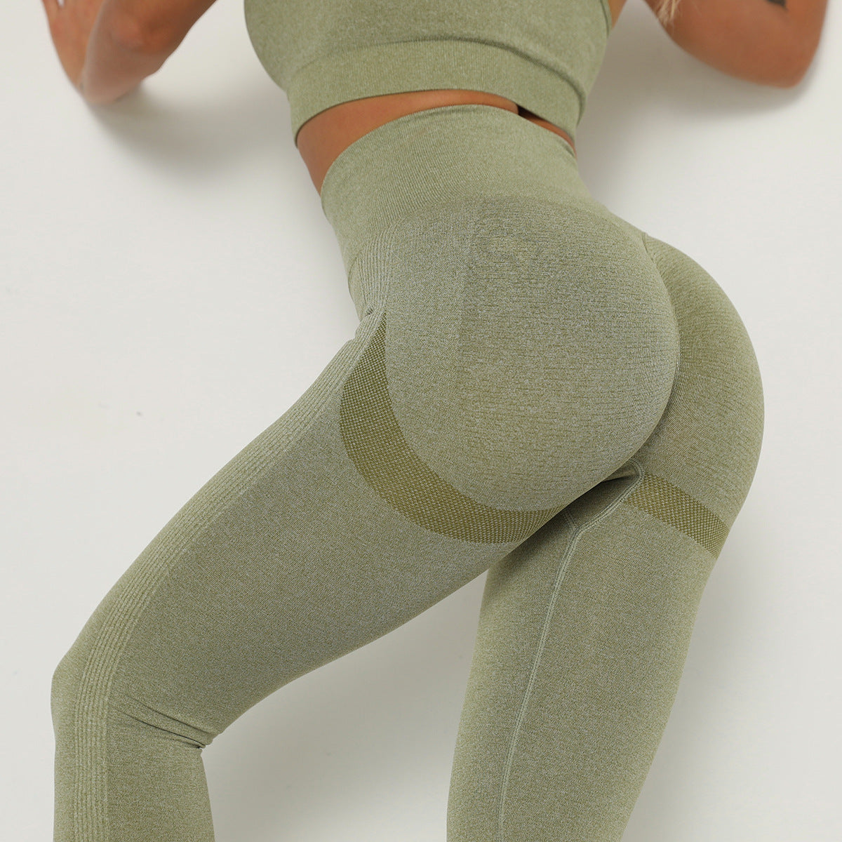 Green leggings with a subtle pattern on a white background