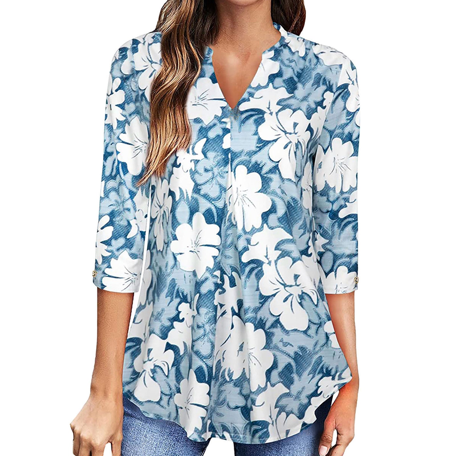 Woman wearing a blue and white floral blouse with rolled-up sleeves on a white background