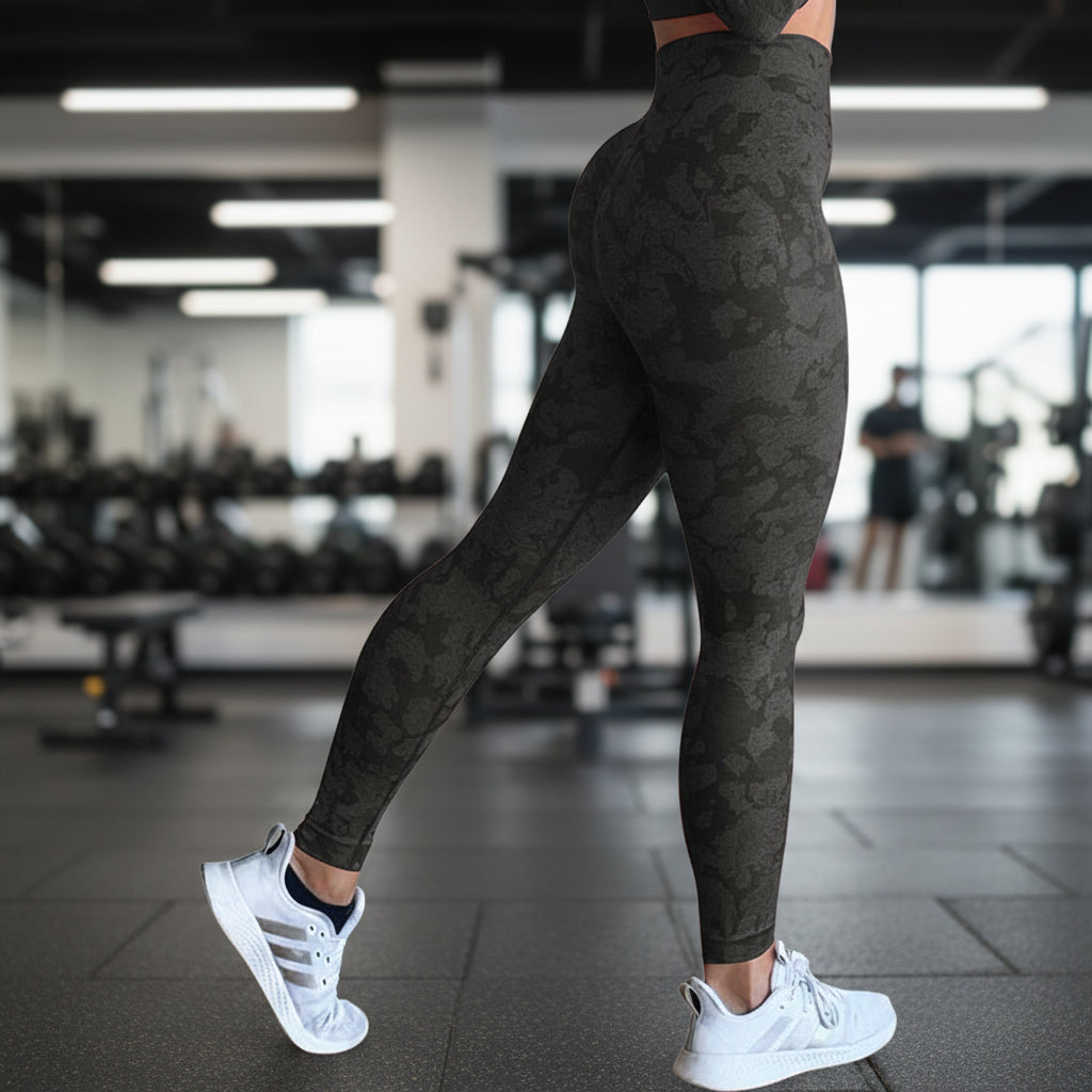 Person wearing black patterned leggings on a white background