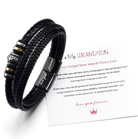 Black braided bracelet with metal accents on a white background