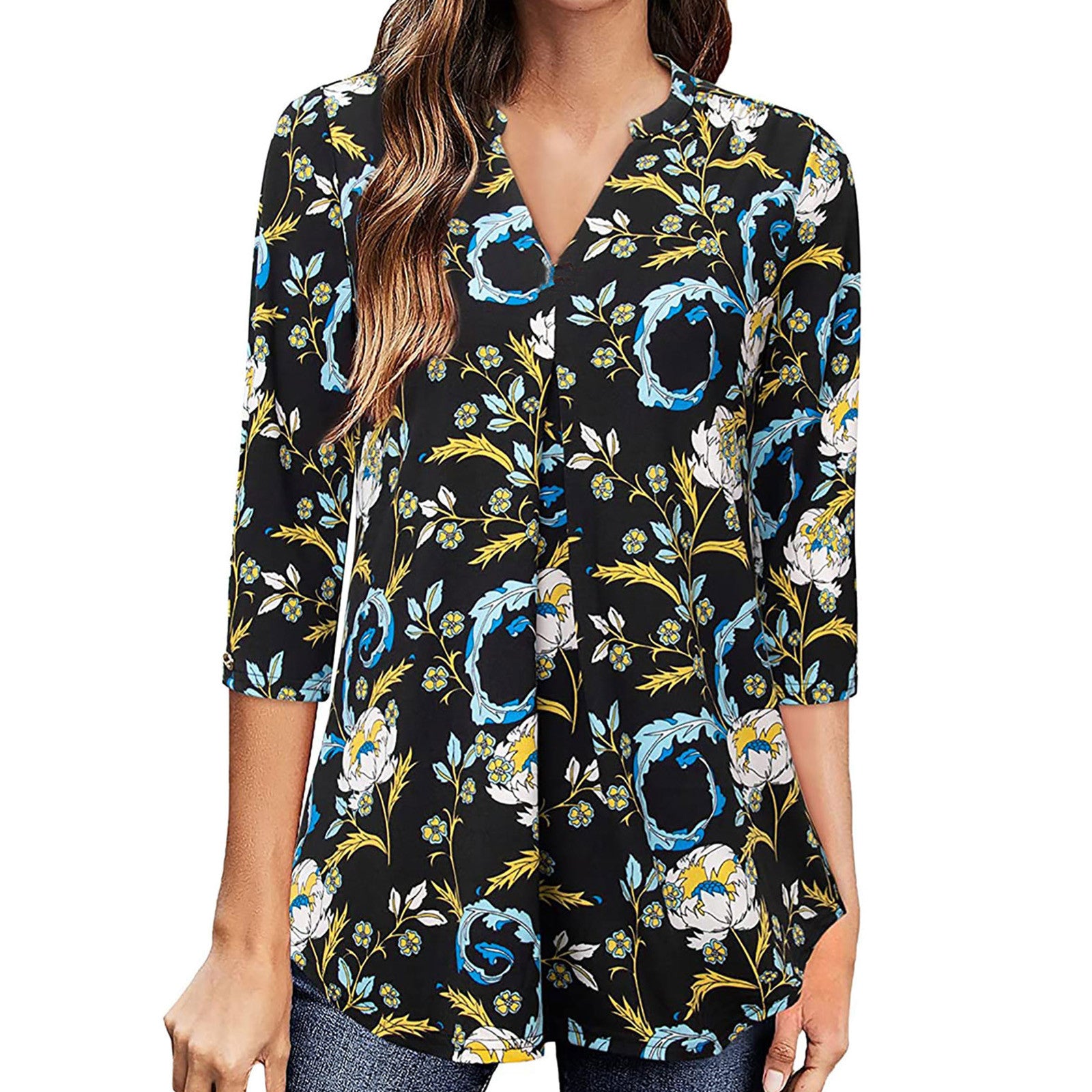 Woman wearing a black floral blouse with blue and yellow flowers on a white background