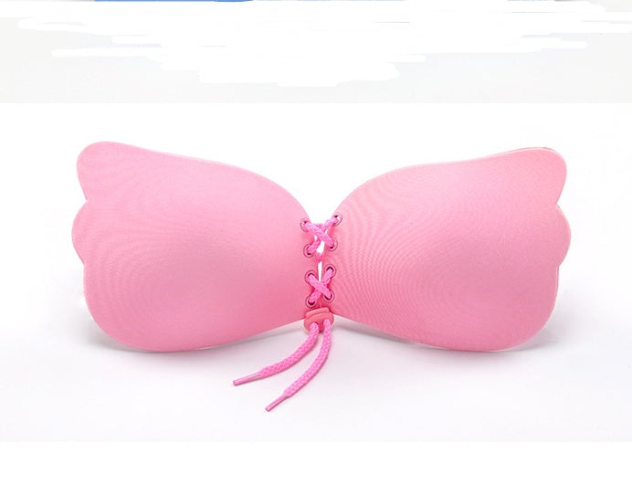 Pink butterfly-shaped object on a white background