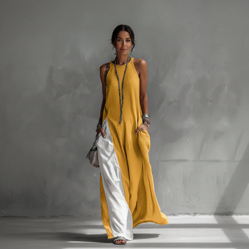 Woman wearing a yellow and white dress against a gray background