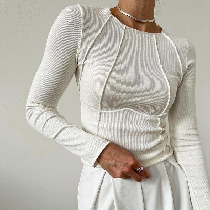 White long-sleeve top and skirt set on a plain background