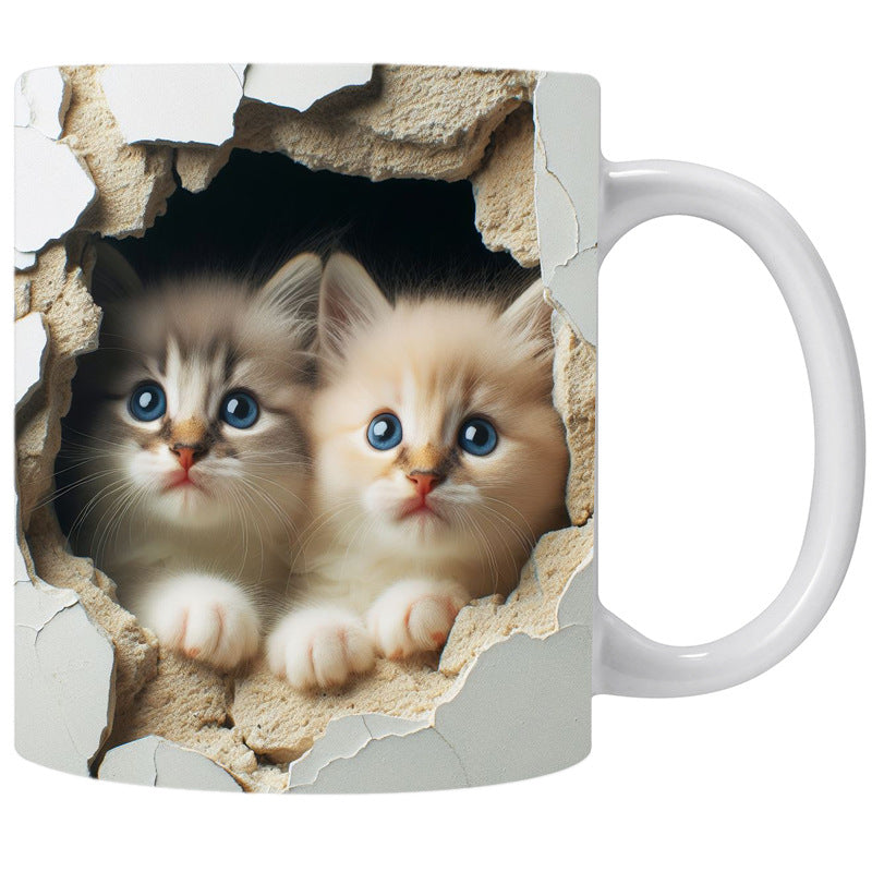 Mug with a design of two kittens peering through a wall.