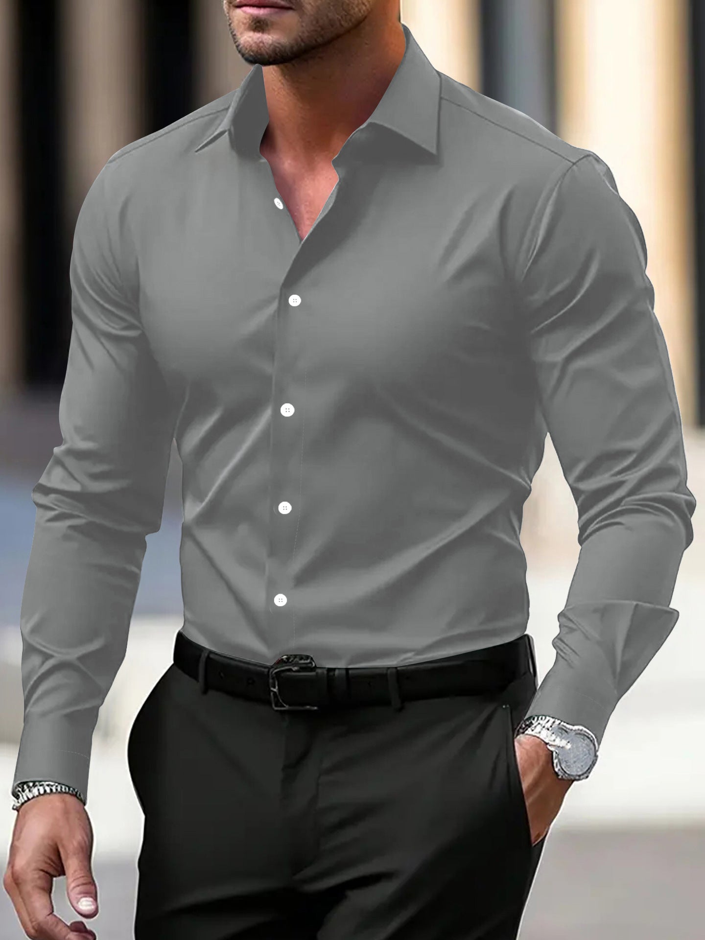 Man wearing a gray dress shirt with black pants in an urban setting