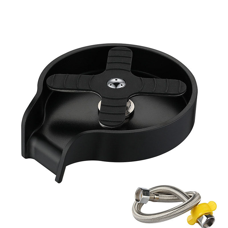 Black plastic component with a metal hose and nozzle on a white background