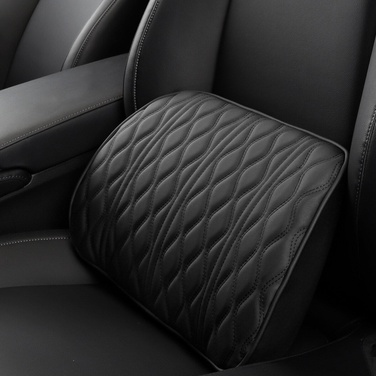 Black quilted car armrest cover in a car interior