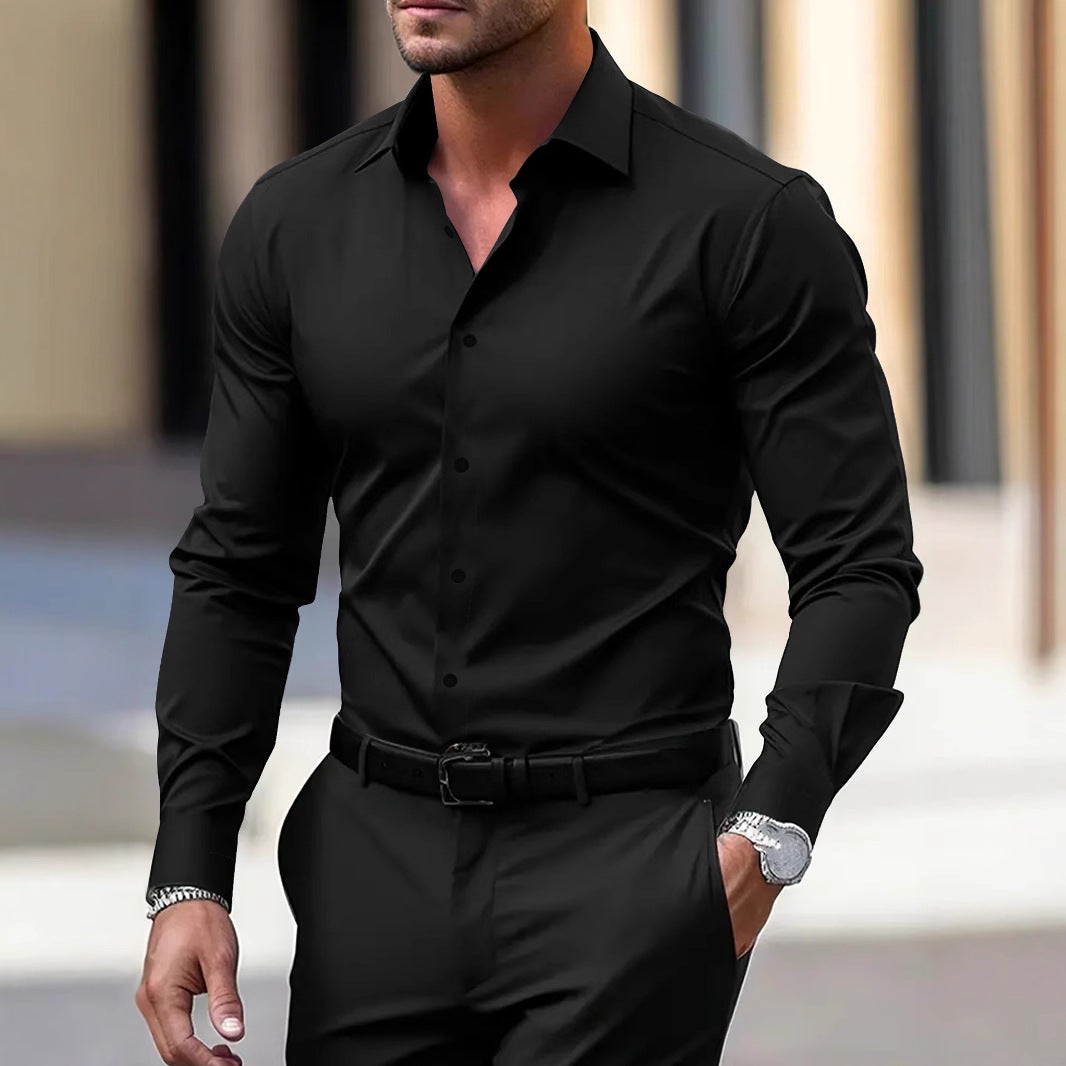 Man wearing a black dress shirt and pants with a blurred background
