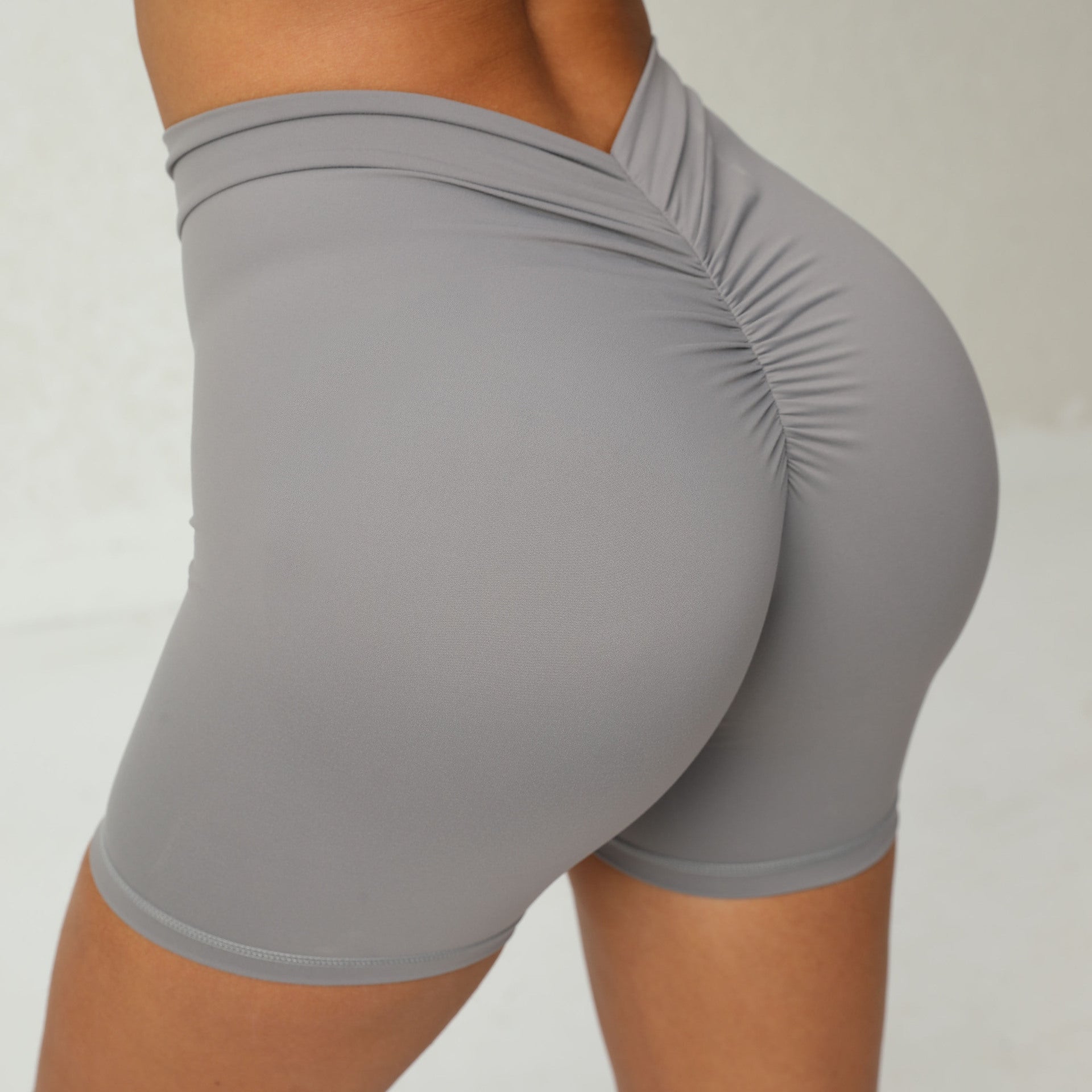 Gray athletic shorts worn by a person on a plain background