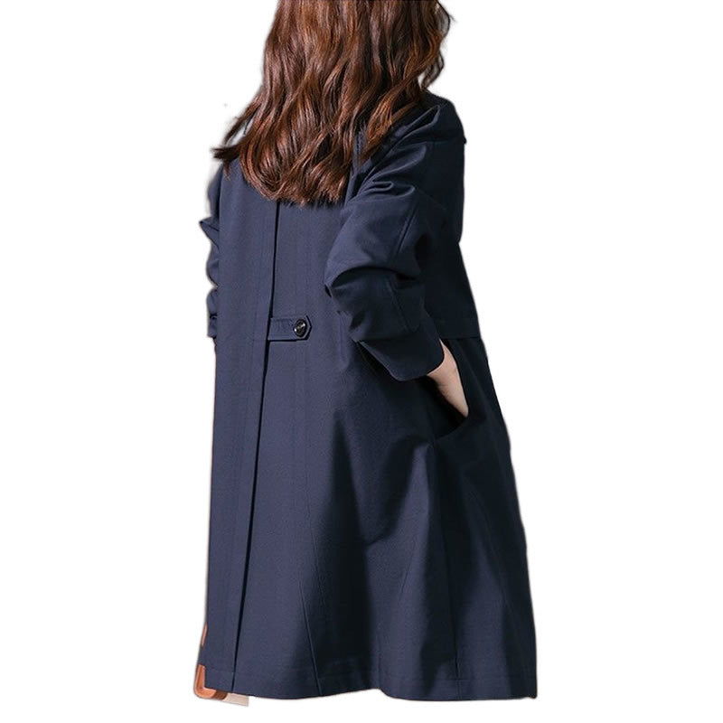 Navy blue coat worn by a person on a white background