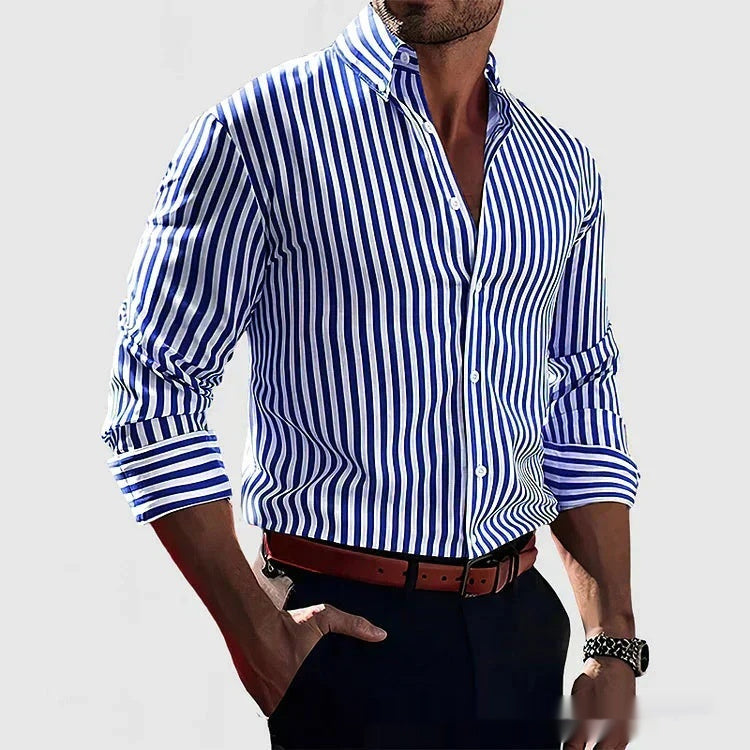 Man wearing a blue and white striped shirt with rolled-up sleeves on a light gray background