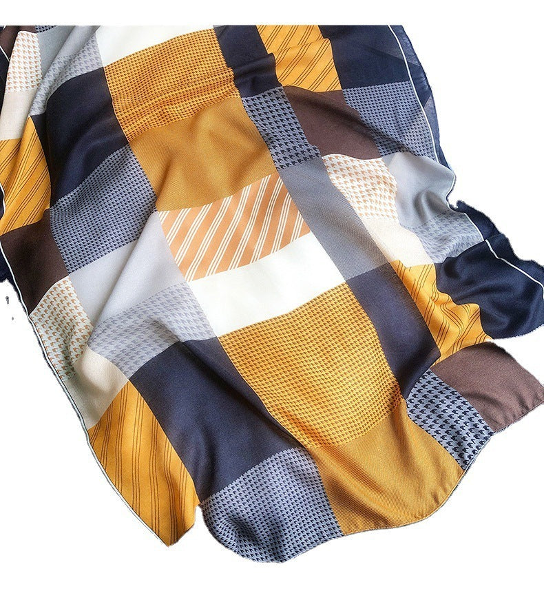 Colorful patchwork fabric with a mix of yellow, blue, and brown patterns on a white background.