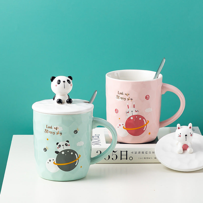 Two mugs with panda designs on a teal background