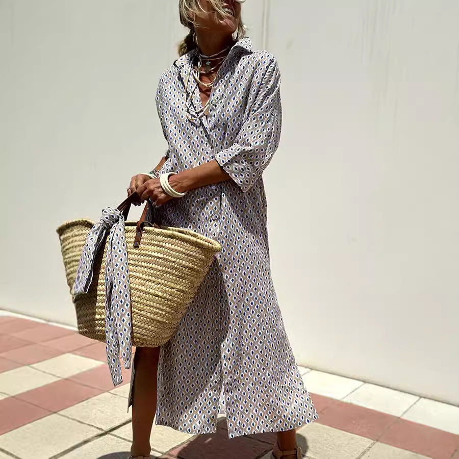 Woman in a polka dot dress holding a straw bag against a plain background