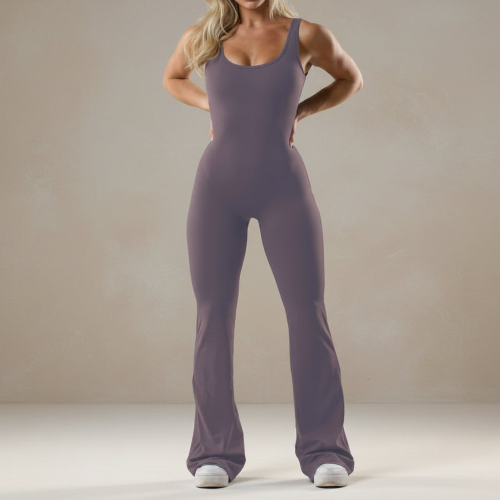 Person wearing a purple jumpsuit on a plain background