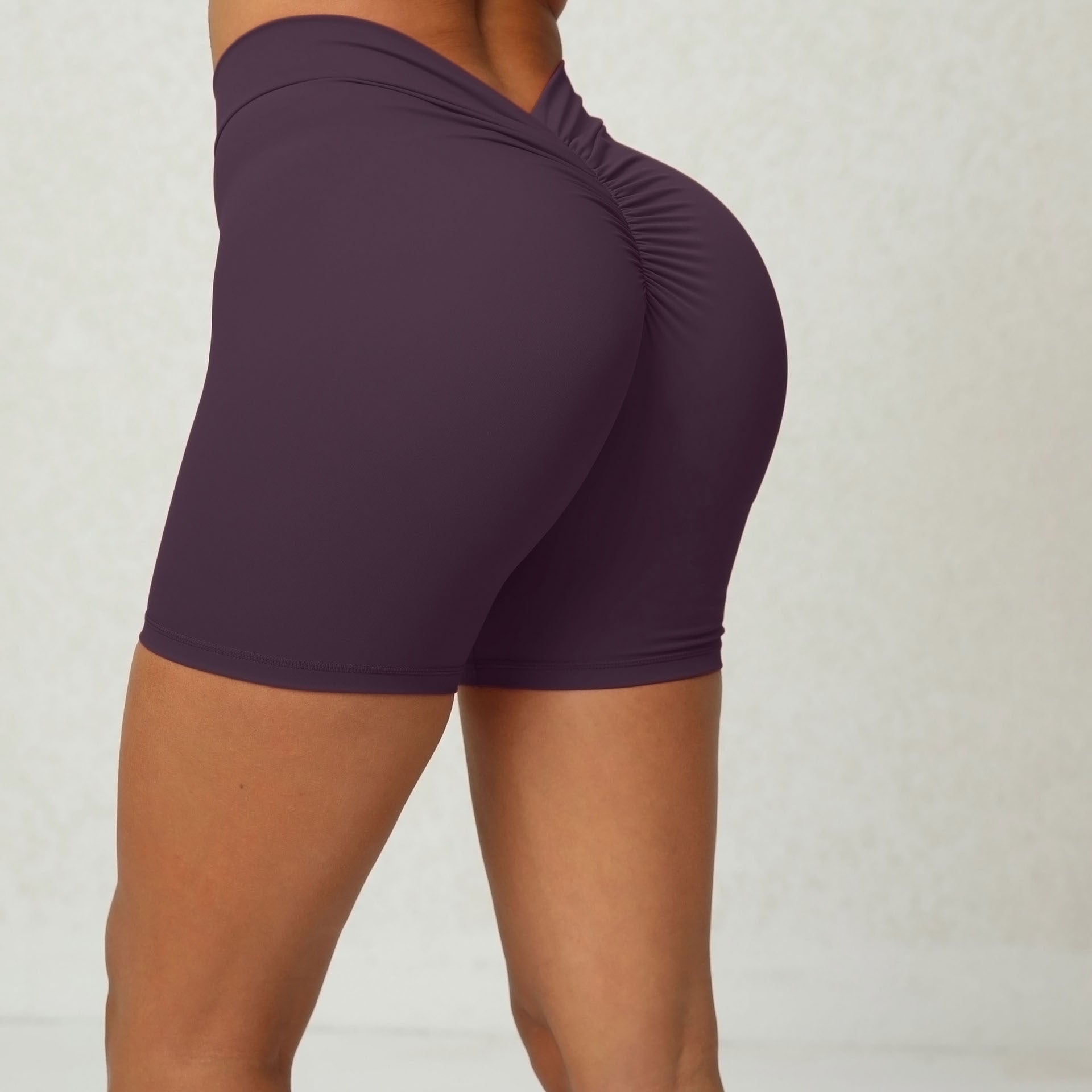 Purple athletic shorts worn by a person on a plain background