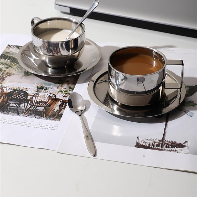 Silver tea set with a cup, saucer, and teapot on a magazine