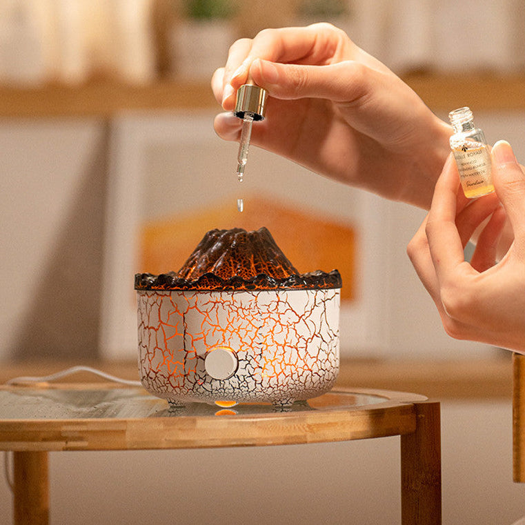 Person pouring a liquid into a cracked-patterned lamp on a wooden table.
