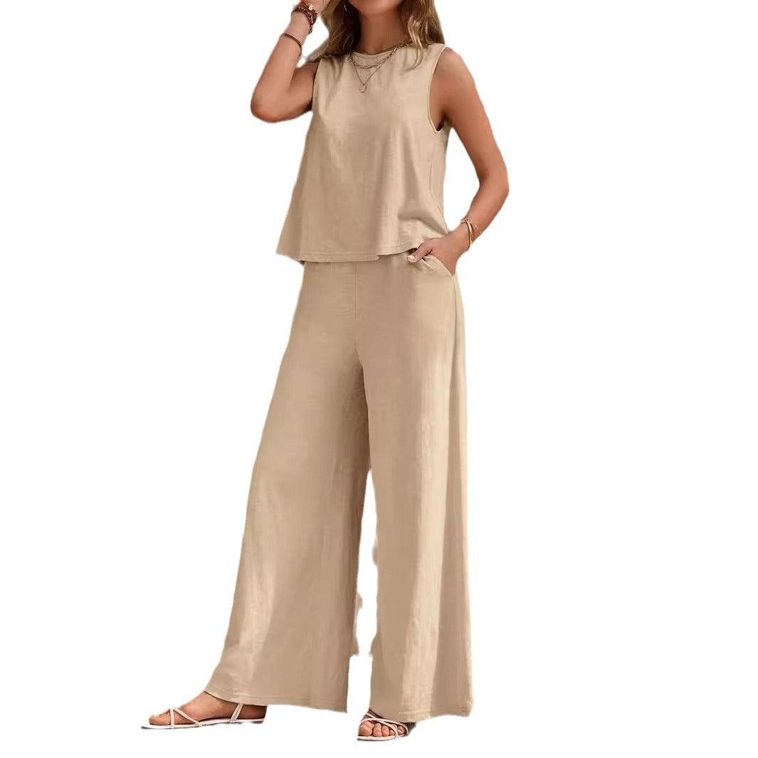Woman wearing a beige sleeveless top and wide-leg pants on a white background