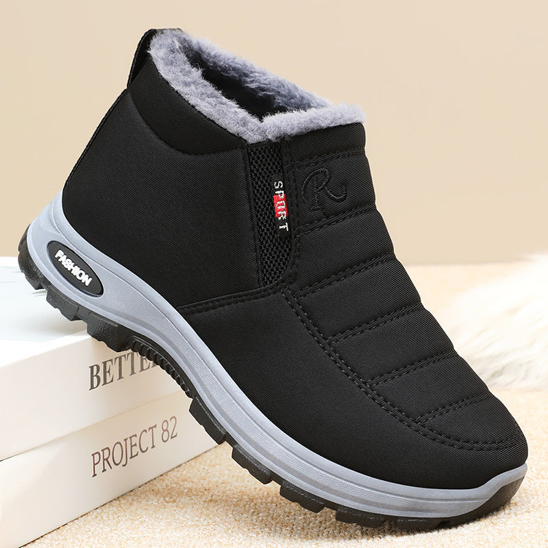 Black winter shoe with gray lining on a beige surface