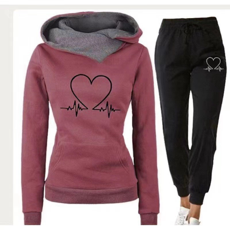 Maroon hoodie with heart design and black pants with heart graphic on a white background