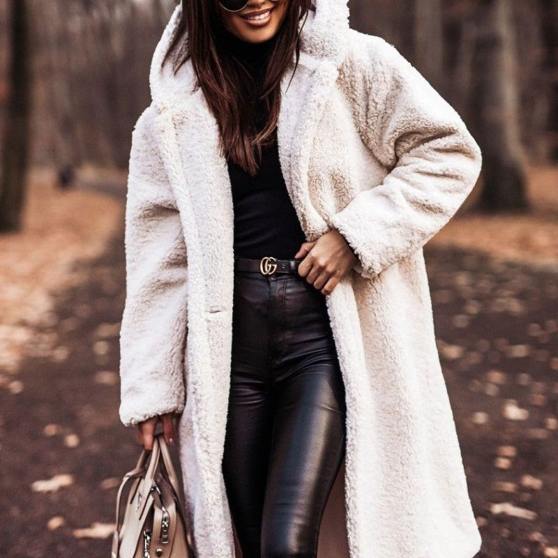 Person wearing a white fluffy coat in an outdoor setting