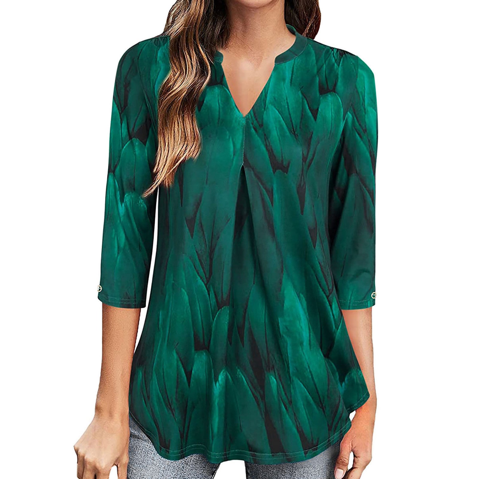 Green patterned blouse worn by a model on a white background