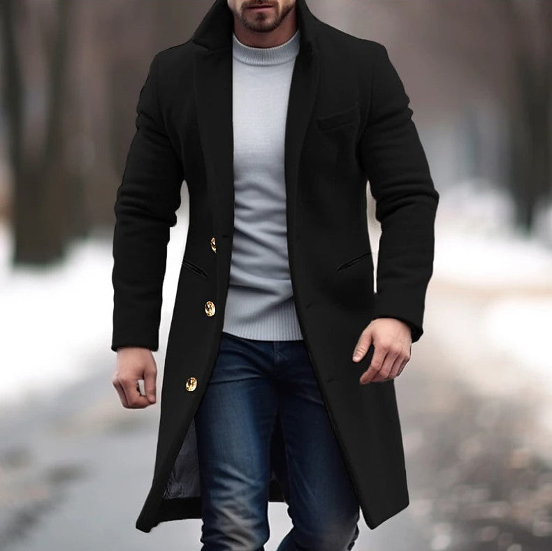 Man wearing a black coat with gold buttons in an outdoor setting