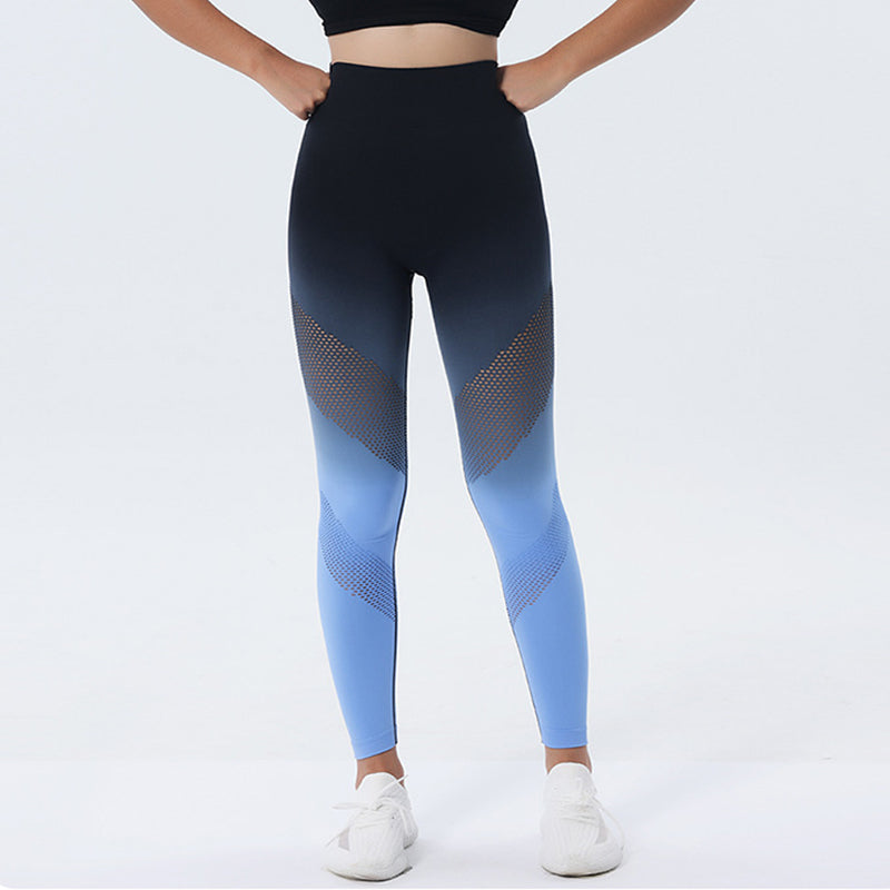 Person wearing black and blue gradient leggings on a white background