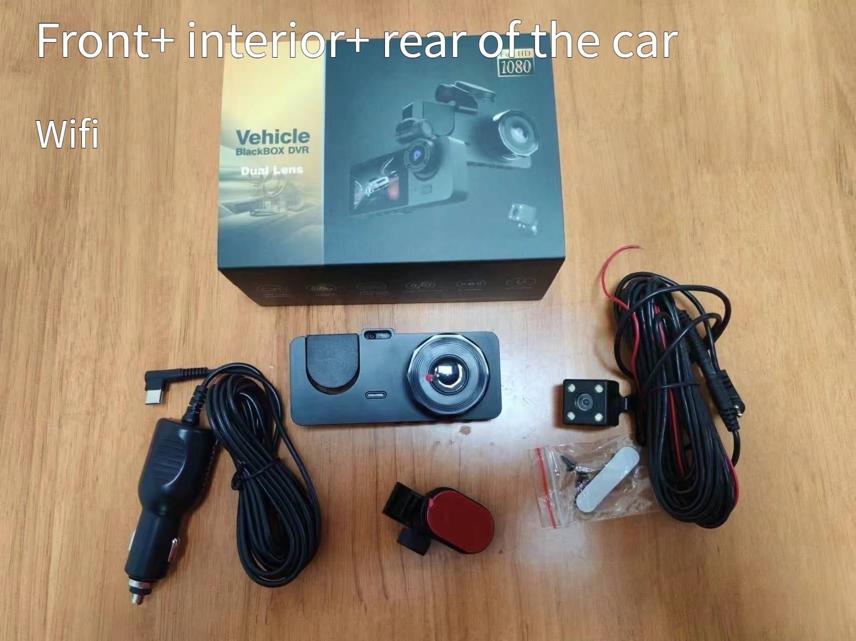 Car dashboard camera set with box, cables, and accessories on a wooden surface