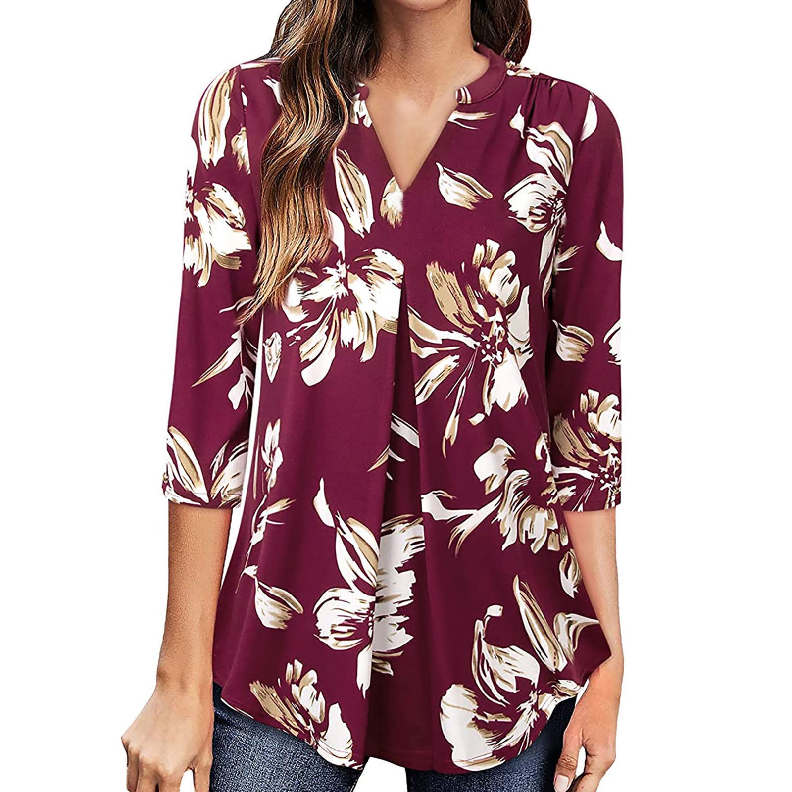 Woman wearing a burgundy floral blouse on a white background